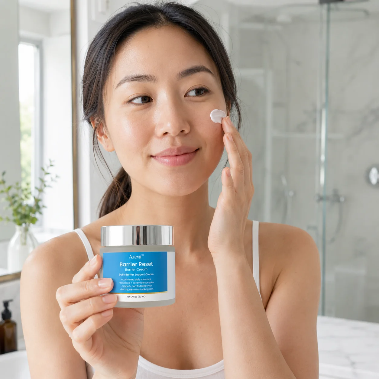 Applying a dab of Barrier Reset cream to the cheek